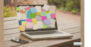 computer covered with sticky notes