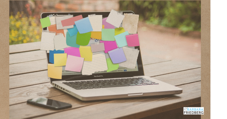 computer covered with sticky notes